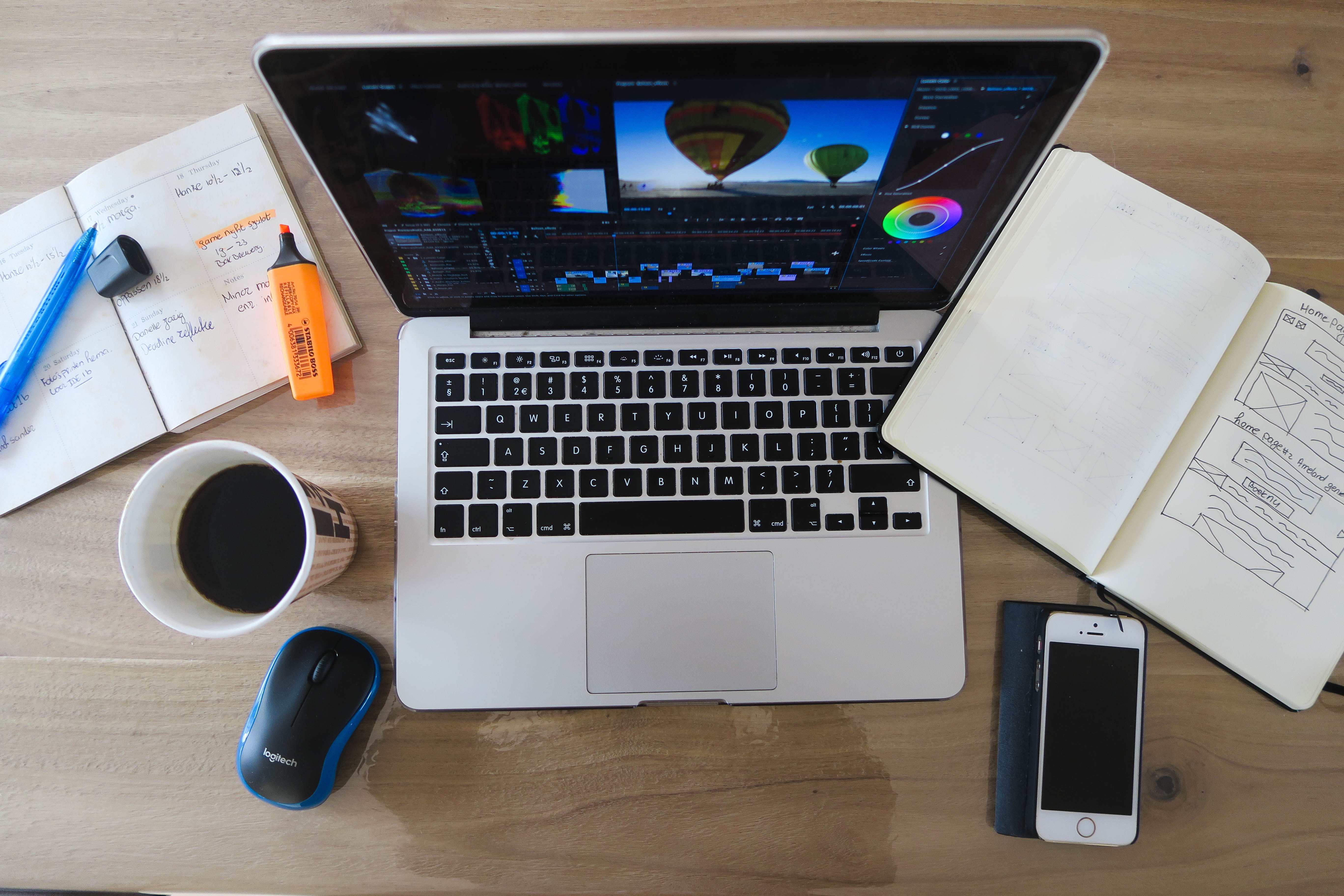 photo of laptop and notepad on table
